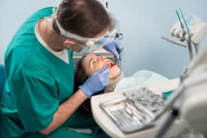 male-dentist-performing-patient-dental-checkup