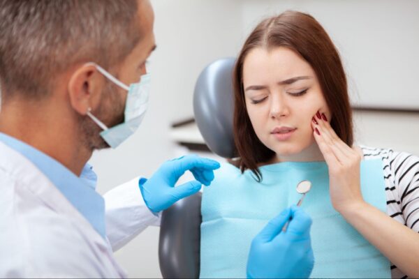 young-woman-painful-toothache-dentist-consultation